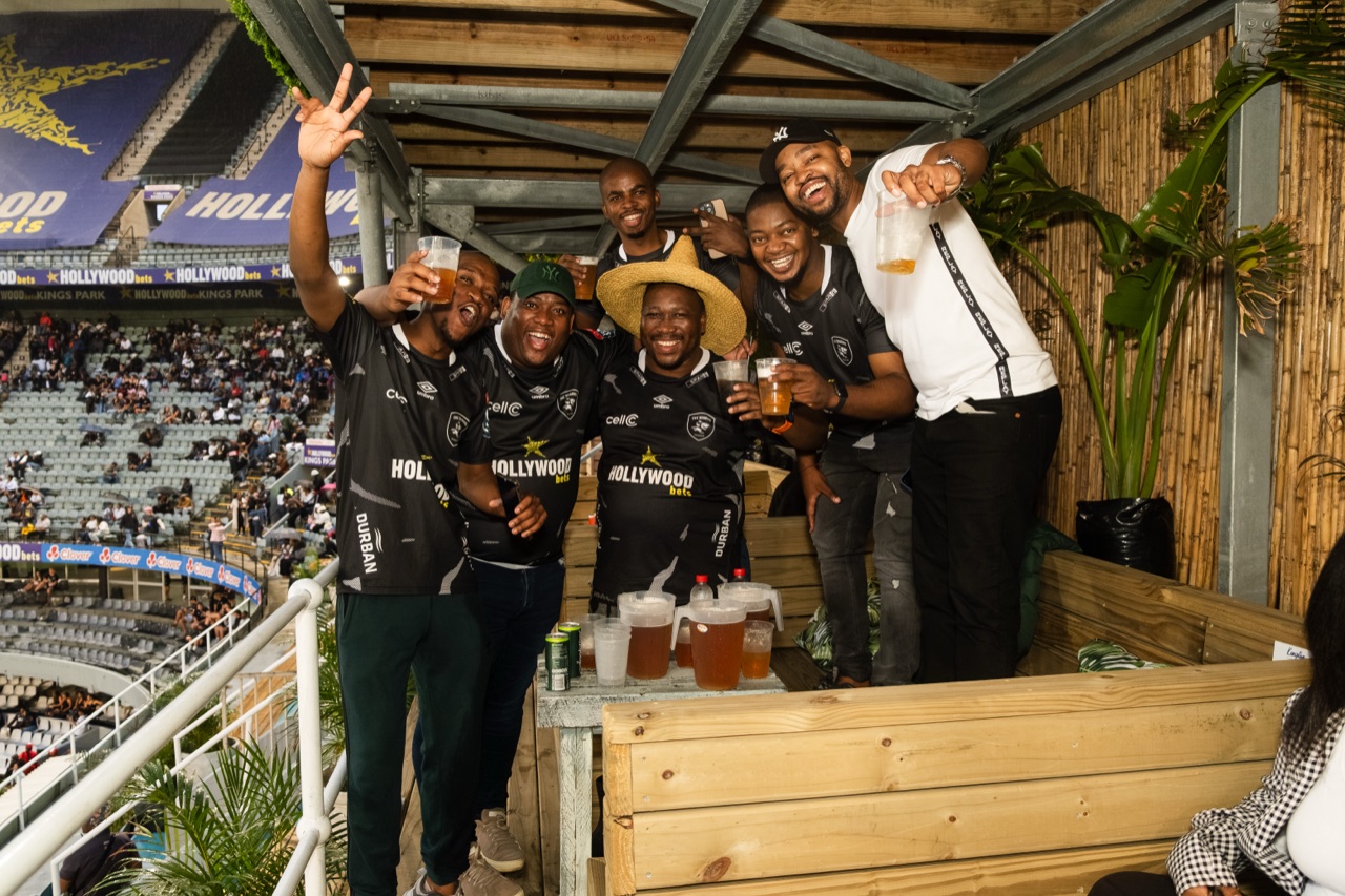 A booth of friends cheering on match night